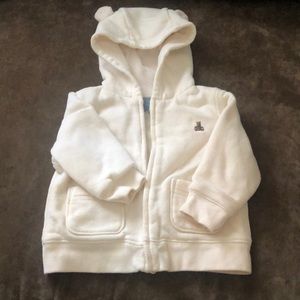 A unisex sweat suit for a baby.